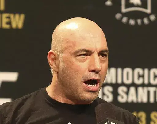Joe Rogan is seen during a weigh-in before UFC 211 on Friday, May 12, 2017, in Dallas. Spotify has penned a new multi-year partnership deal with Rogan, Friday, Feb. 2, 2024. The enormously popular show will soon also be available on competing platforms, including YouTube and Apple Podcasts. ( AP Photo/Gregory Payan, File)