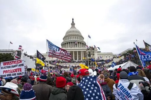 Rioters loyal to President Donald Trump rally at the U.S. Capitol in Washington on Jan. 6, 2021. The House committee investigating the Jan. 6 attack on the U.S. Capitol has scheduled its next hearing for Oct. 13, 2022, pushing the investigation back into the limelight less than three weeks before the midterm election that will determine control of Congress. (AP Photo/Jose Luis Magana, File)