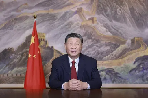 In this photo released by Xinhua News Agency, Chinese President Xi Jinping delivers a New Year message on Tuesday, Dec. 31, 2024 in Beijing to ring in 2025. (Ju Peng/Xinhua via AP)