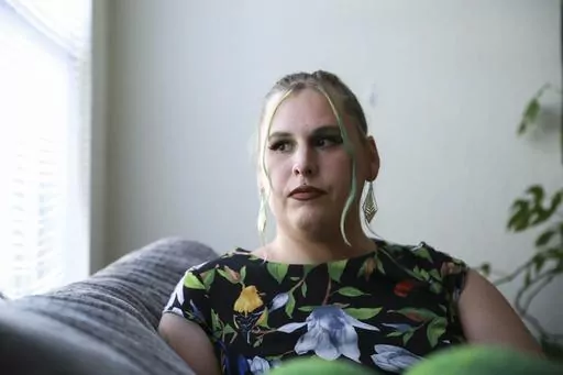 Sage Chelf poses for a photo at her home in Orlando, Fla., May 27, 2023. Recent Florida legislation has caused Chelf, a trans woman, to lose access to her hormone replacement therapy. She's hoping to move to Illinois in the coming weeks to stay with her girlfriend and regain access to care. (AP Photo/Laura Bargfeld)