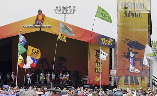 Flags fly in front of the Festival Stage during the New Orleans Jazz & Heritage Festival on May 7, 2023. The Fair Grounds Race Course, which plays host to the 2024 New Orleans Jazz and Heritage Festival, begins its annual transformation in earnest Tuesday, March 26, 2024, as organizers prepare to take over the field this Spring for two weekends of music, food and fun. (Brett Duke/The Advocate via AP, File)