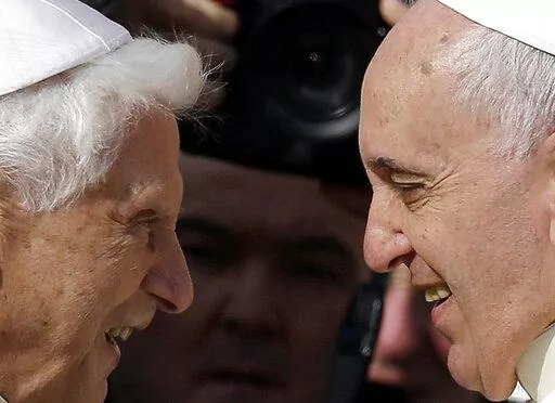 Pope Francis, right, greets Pope Emeritus Benedict XVI prior to the start of a meeting with elderly faithful in St. Peter's Square at the Vatican, on Sept. 28, 2014. Emeritus Pope Benedict XVI turned 95 this past weekend, a significant milestone on its own but even more given he has now been a retired pope longer than he was a reigning one.  To mark the occasion, a new book published Thursday, April 21, 2022 sets out to examine the current state of Vatican affairs not so much through the lens of