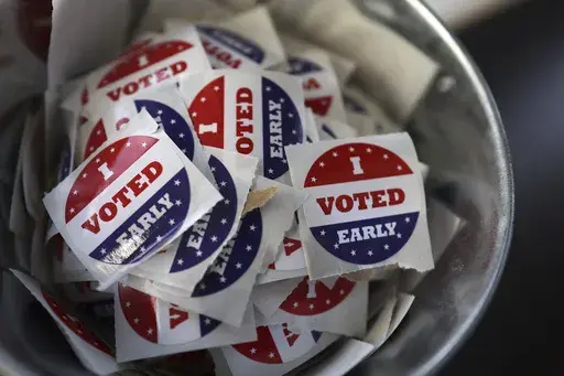"I Voted Early" stickers sit in a bucket by the ballot box at the City of Minneapolis early voting center, Thursday, Sept. 19, 2024, in St. Paul, Minn. In-person voting in the 2024 presidential contest begins Friday in three states, including Democratic vice presidential candidate Tim Walz's home state of Minnesota, with just over six weeks left before Election Day. (AP Photo/Adam Bettcher)
