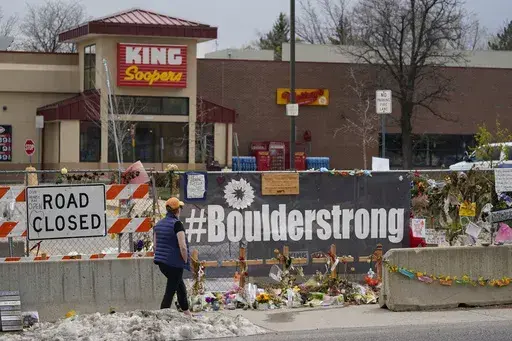 Tributes cover the temporary fence around the King Soopers grocery store in which 10 people died in a mass shooting in late March on Friday, April 23, 2021, in Boulder, Colo. (AP Photo/David Zalubowski, File)