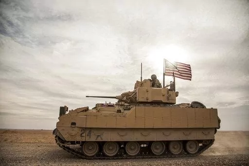 American soldiers drive a Bradley fighting vehicle during a joint exercise with Syrian Democratic Forces at the countryside of Deir Ezzor in northeastern Syria, Dec. 8, 2021. President Joe Biden said on Jan. 4, 2023, that's he's weighing sending Bradley Fighting Vehicles to help Ukraine in its effort to combat Russia's ongoing invasion. (AP Photo/Baderkhan Ahmad, File)