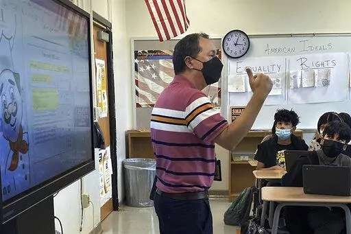 This photo shows Daniel Santos, a middle school history teacher during class, in Houston, in November, 2021. Teachers around the U.S. are confronting classrooms where as many as half of students are absent. That's because they have been exposed to COVID-19 or their families kept them at home out of concern about the surging coronavirus. F  (Courtesy Daniel Santos via AP)