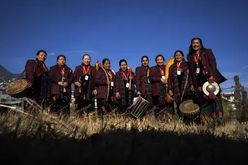 Band members of Shrijanshil Mahila Sanstha, or the Self-Reliant Women’s Group, stand for a photograph before they prepare to play at a wedding in Kathmandu, Nepal, Wednesday, March 6, 2024. Once associated only with men from the Damai community, part of the lowest caste, these nine women have come together to play the naumati baja, or nine traditional instruments. Discrimination based on caste is believed to have caused some Dalit musicians to quit playing naumati baja. (AP Photo/Niranjan Shre