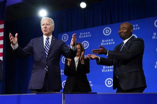 President Joe Biden and Vice President Kamala Harris stand on stage with DNC chair Jaime Harrison at the Democratic National Committee winter meeting, Friday, Feb. 3, 2023, in Philadelphia. (AP Photo/Patrick Semansky)