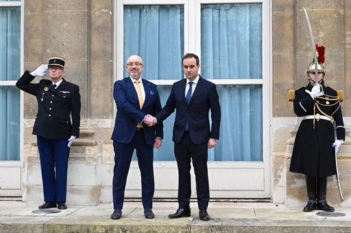French Defense Minister Sebastien Lecornu, center right, and Ukrainian Minister of Defense Oleksii Reznikov pose during Reznikov's official visit at the French Defense Ministry, in Paris Tuesday, Jan. 31, 2023. Ukraine's defense minister pays his first official visit to France, meeting with Macron and the defense minister, as Ukraine sets its sights on Western warplanes and other heavy weaponry to push back Russian forces. (Julie Sebadelha, Pool via AP)