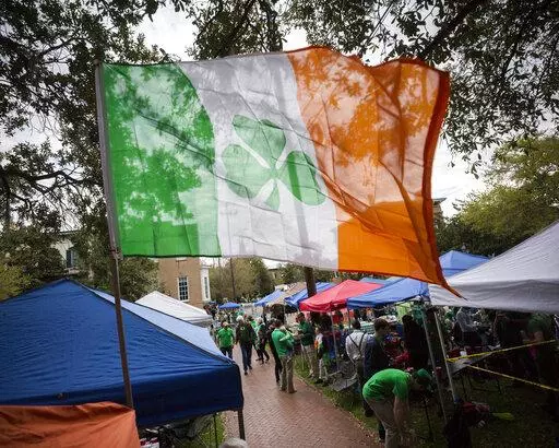 Revelers prepare for the 195-year-old St. Patrick's Day parade on one of the city's historic squares, Saturday, March 16, 2019, in Savannah, Ga.  Savannah is gearing up for a big comeback of its most profitable holiday Thursday, March 17, 2022, as its beloved St. Patrick's Day parade returns for the first time since 2019.  .(AP Photo/Stephen B. Morton, File)