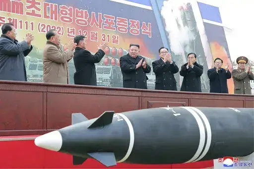 In this photo provided by the North Korean government, North Korean leader Kim Jong Un, center, attends a ceremony of donating 600mm super-large multiple launch rocket system at a garden of the Workers’ Party of Korea headquarters in Pyongyang, North Korea Saturday, Dec. 31, 2022. Independent journalists were not given access to cover the event depicted in this image distributed by the North Korean government. The content of this image is as provided and cannot be independently verified. Korea