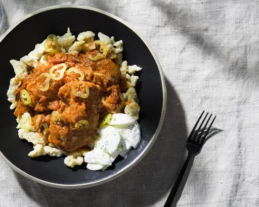 This image released by Milk Street shows a recipe for Hungarian chicken paprikash. (Milk Street via AP)
