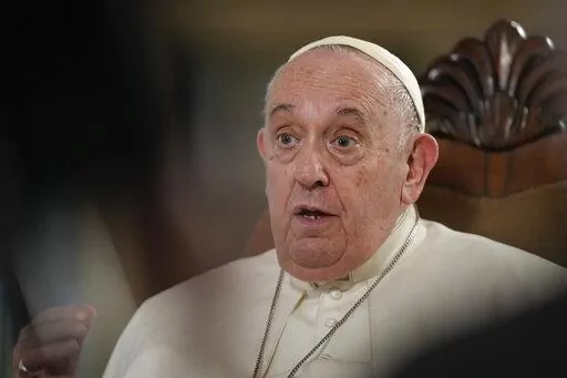 Pope Francis speaks during an interview with The Associated Press at The Vatican, Tuesday, Jan. 24, 2023. According to the pope, the arms industry has brought untold death and destruction to the world. “The world is obsessed with weapons,” he said. (AP Photo/Andrew Medichini)