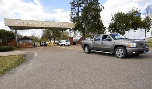 Traffic leaves the front gate to the Mississippi State Penitentiary in Parchman, Miss., Nov. 17, 2021. In January 2023, lawsuits that challenged shoddy living conditions at the prison were dismissed after attorneys said improvements have been made there since 2020. The changes include installation of air conditioning in most of the prison and updates to the electrical, water and sewer systems. (AP Photo/Rogelio V. Solis, File)