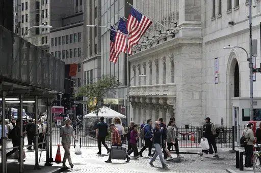 People pass the New York Stock Exchange on Oct. 1, 2024, in New York. (AP Photo/Peter Morgan, File)