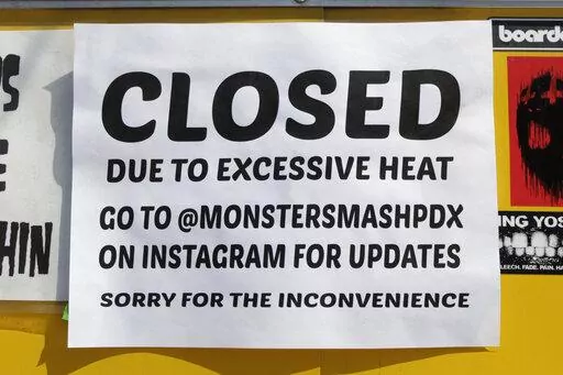 A closed sign is posted outside Rico Loverde's Monster Smash Burgers food cart in Portland, Ore., on Wednesday, July 27, 2022.  (AP Photo/Gillian Flaccus)
