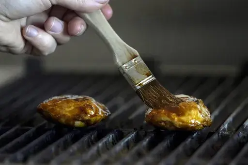 Chef Zach Tyndall prepares Good Meat's cultivated chicken at the Eat Just office in Alameda, Calif., June 14, 2023. Lab-grown meat is not currently available in any U.S. grocery stores or restaurants. If some lawmakers have their way, it never will be. (AP Photo/Jeff Chiu, File)