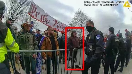 In this image from U.S. Capitol Police video, released and annotated by the Justice Department in the sentencing memorandum, Patrick McCaughey III,, appears on police body-worn camera footage at the U.S. Capitol on Jan. 6, 2021, in Washington. McCaughey who used a stolen riot shield to crush a police officer in a doorframe during the U.S. Capitol insurrection was sentenced on April 14, 2023, to more than seven years in prison for his role in one of the most violent episodes of the Jan. 6 attack.