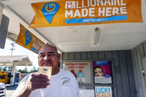 Electrician Jose Valles, 59, from Rancho Cucamonga, Calif., buys a SuperLotto Plus ticket at the gas station that previously sold the $2.04 billion-winning Powerball ticket award at Joe's Service Center, a Mobil gas station at Woodbury Road and Fair Oaks Avenue in Altadena, Calif., Friday, Jan. 6, 2023. Lottery players whose numbers didn't hit or who forgot to even buy a ticket will have another shot at a nearly $1 billion Mega Millions prize. The estimated $940 million jackpot up for grabs Frid