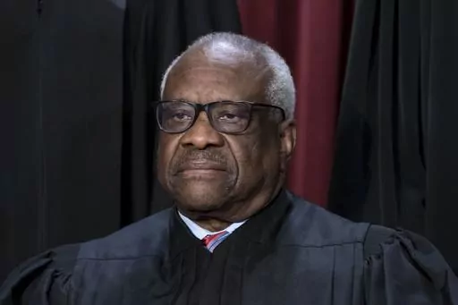 Associate Justice Clarence Thomas joins other members of the Supreme Court as they pose for a new group portrait, at the Supreme Court building in Washington, Oct. 7, 2022. Thomas has for more than two decades accepted luxury trips nearly every year from Republican megadonor Harlan Crow without reporting them on financial disclosure forms, ProPublica reports. (AP Photo/J. Scott Applewhite, File)