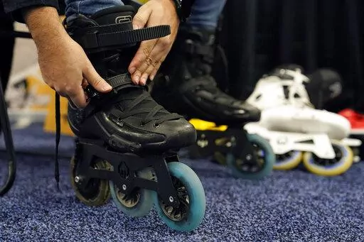 Mohamed Soliman of Atmos Gear dons Atmos Gear inline electric skates during CES Unveiled before the start of the CES tech show, Tuesday, Jan. 3, 2023, in Las Vegas. More than a thousand startups are showcasing their products at the annual CES tech show in Las Vegas, hoping to create some buzz around their gadgets and capture the eyes of investors who can help their businesses grow.(AP Photo/John Locher, File)