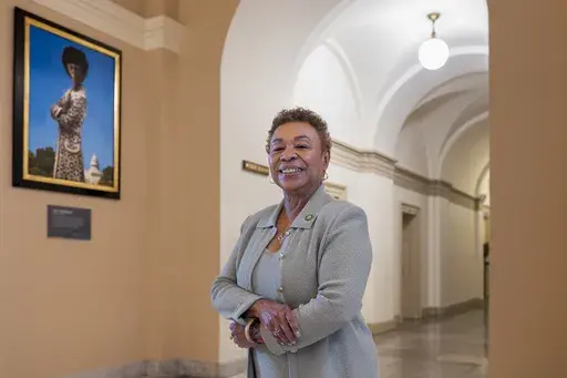 Rep. Barbara Lee, D-Calif., stands beside a portrait of her friend and mentor, Shirley Chisolm, the first Black woman elected to Congress, at the Capitol in Washington, Tuesday, Dec. 17, 2024. (AP Photo/J. Scott Applewhite)