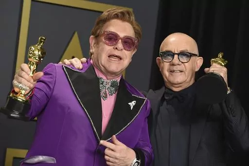 Elton John, left, and Bernie Taupin, winners of the award for best original song for "(I'm Gonna) Love Me Again" from "Rocketman", pose in the press room at the Oscars on Sunday, Feb. 9, 2020, in Los Angeles. Taupin's memoir, "Scattershot: Life, Music, Elton, and Me" releases this week. (Photo by Jordan Strauss/Invision/AP, File)