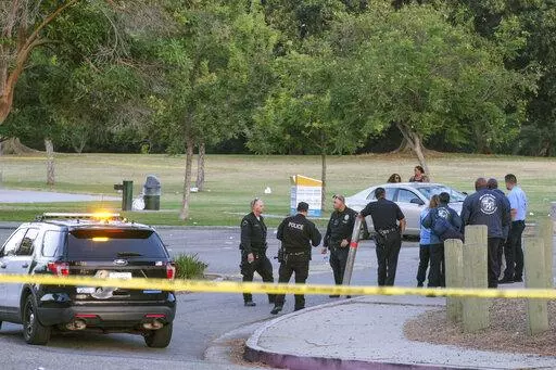 Police officers stand near the scene of a shooting at Peck Park in San Pedro, Calif., Sunday, July 24, 2022. (AP Photo/Ringo H.W. Chiu)