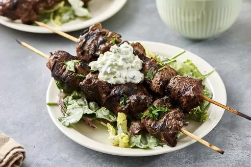 A recipe for lamb kebabs appears in New York. Kebabs can be made from many types of meat, seafood, fish, poultry or vegetables, or a combination thereof. (Cheyenne Cohen via AP)