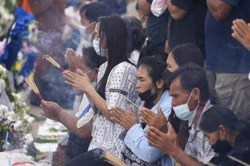 Relatives of the victims of a mass killing attack gather for a Buddhist ceremony in front of the Young Children's Development Center in the rural town of Uthai Sawan, north eastern Thailand, Sunday, Oct. 9, 2022. A former police officer burst into a day care center in northeastern Thailand on Thursday, killing dozens of preschoolers and teachers before shooting more people as he fled. (AP Photo/Sakchai Lalit)