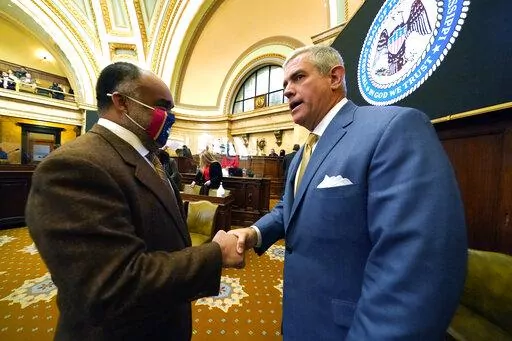 House Speaker Philip Gunn, R-Clinton, right, greets Rep. Charles Young, D-Meridian, prior to the start of the 90-day session at the Mississippi State Capitol in Jackson, Miss., Tuesday, Jan. 4, 2022. Gunn is pushing a plan to eliminate the state income tax over several years. (AP Photo/Rogelio V. Solis, File)