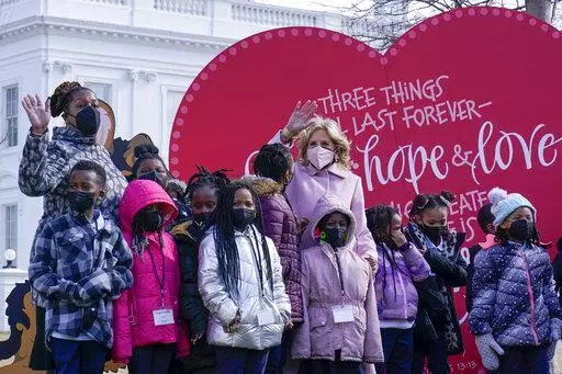 First lady Jill Biden poses for a photo with Aiton Elementary School students and staff as she welcomes school children to the White House in Washington, Monday, Feb. 14, 2022, to celebrate Valentine's Day. (AP Photo/Susan Walsh)
