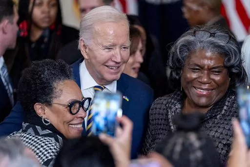 President Joe Biden takes a photograph with Housing and Urban Development Secretary Marcia Fudge, left, and United States Ambassador to the United Nations Linda Thomas-Greenfield, right, during a reception in recognition of Black History Month in the East Room of the White House in Washington, Tuesday, Feb. 6, 2024. (AP Photo/Andrew Harnik)