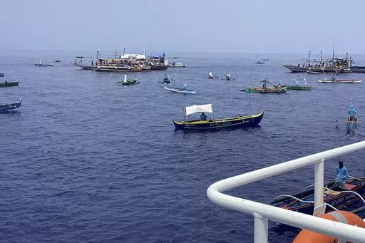 In this photo provided by the Philippine Coast Guard, fishing boats carrying activists and volunteers belonging to a nongovernment coalition called Atin Ito, Tagalog for This is Ours, pass by waters off Palauig Point, Zambales province, northwestern Philippines as they head towards Scarborough Shoal on Wednesday May 15, 2024. A flotilla of about 100 mostly small fishing boats led by Filipino activists sailed Wednesday to a disputed shoal in the South China Sea, where Beijing's coast guard and su