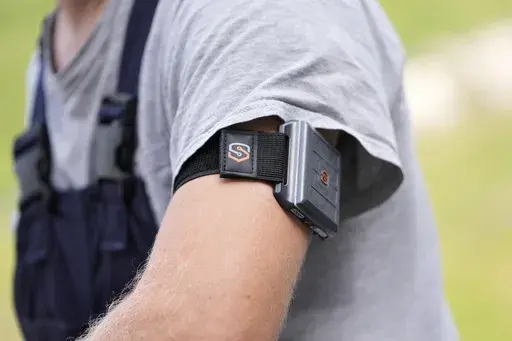 A SlateSafety armband is worn by Wyatt Fischer, a furnace mason employee at Cardinal Glass, Thursday, Aug. 22, 2024, in Menomonie, Wis. (AP Photo/Abbie Parr)
