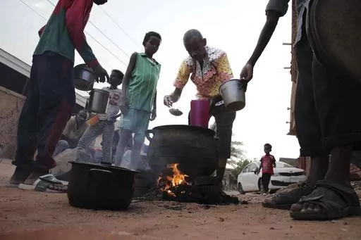 People prepare food in a Khrtoum neighborhood on June 16, 2023. Sudan’s warring parties began a cease-fire Sunday morning, June 18, 2023, after two months of fighting pushed the African nation into chaos. (AP Photo, File)