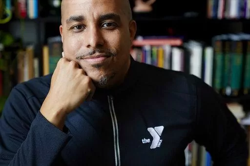 Rico X poses at his home March 14, 2022, in Hermitage, Tenn. X, who oversees the before- and afterschool programs run by the YMCA of Middle Tennessee, says enrollment has had to be capped as parents return to work after the COVID pandemic because of staff shortages, leaving capacity at about 70% of what it was before the pandemic. (AP Photo/Mark Humphrey)