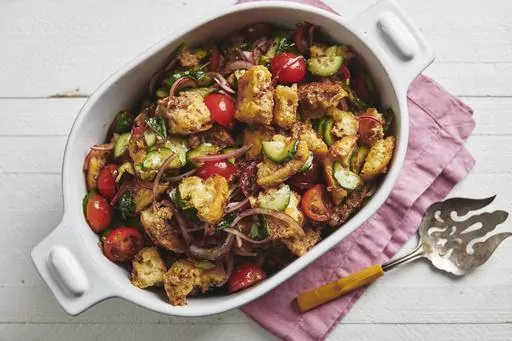 This image shows a recipe for tomato panzanella salad. The classic Tuscan salad was originally created to use up stale bread. (Cheyenne Cohen via AP)