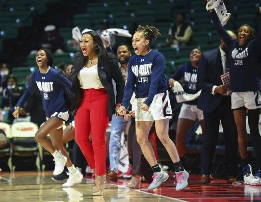 Jackson State head coach Tomekia Reed celebrates with the sidelines during the first half of an NCAA college basketball game against Alabama State in the championship of the Southwestern Athletic Conference tournament, Saturday, March 12, 2022, at Bartow Arena in Birmingham, Ala. (AP Photo/Julie Bennett)