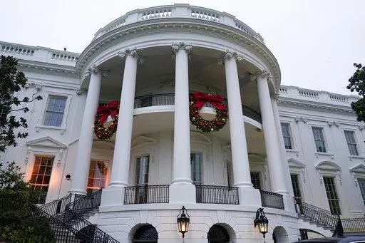 Wreaths hang on the Truman Balcony of the White House in Washington, Nov. 27, 2022. President Joe Biden celebrated a quiet Christmas with his family at the White House over a record-setting cold and windy weekend in the nation’s capitol. (AP Photo/Susan Walsh, File)