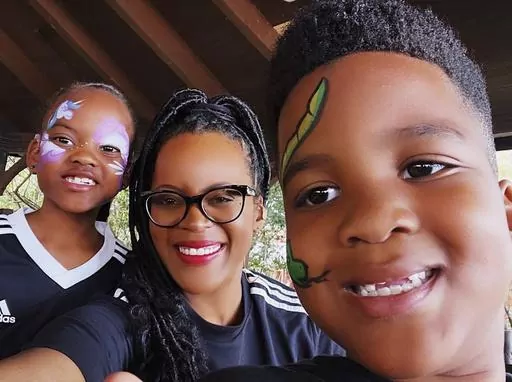 This image provided by Lakesha Cole shows Kirby, Lakesha and Keegan Cole during winter school break on December 30, 2022, at Legoland in Winter Haven, Fla. Family fun and a flexible schedule are priorities during school breaks, but Cole begins putting systems in place to organize her home and get her kids on an early bedtime schedule ahead of the first day of school. (Lakesha Cole via AP)