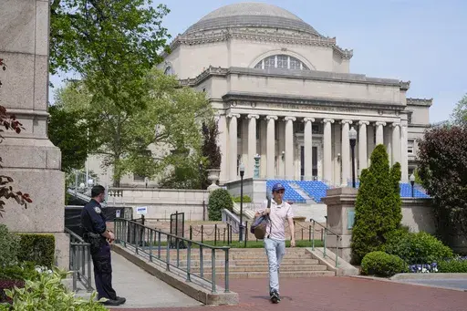 A New York City police officer keeps watch on the campus of Columbia University in New York, Monday, May 6, 2024. (AP Photo/Seth Wenig, File)