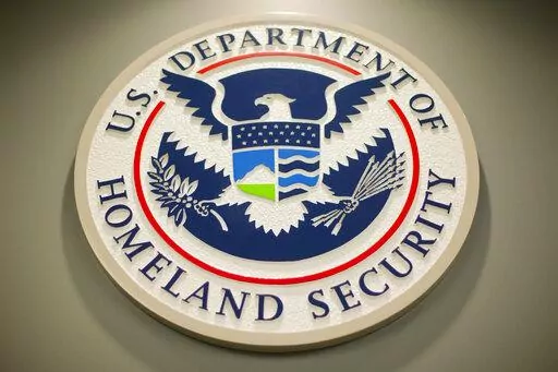 The Homeland Security logo is seen during a joint news conference in Washington, Feb. 25, 2015. The Homeland Security Department said Friday that Cameroonians would be temporarily shielded from deportation, saying extreme violence between government forces and armed separatists in the African nation made conditions unsafe for people to return. (AP Photo/Pablo Martinez Monsivais, File)