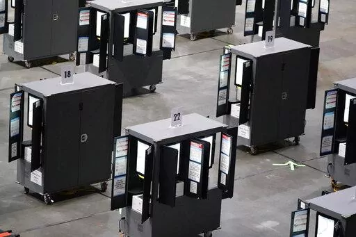 Voting machines fill the floor for early voting at State Farm Arena on Monday, Oct. 12, 2020, in Atlanta. In an advisory sent to state election officials, and obtained by The Associated Press in advance of its expected release on Friday, June 3, 2022, the nation’s leading cybersecurity agency says that electronic voting machines from a leading vendor used in at least 16 states have software vulnerabilities. The U.S. Cybersecurity and Infrastructure Agency, or CISA, said there is no evidence th