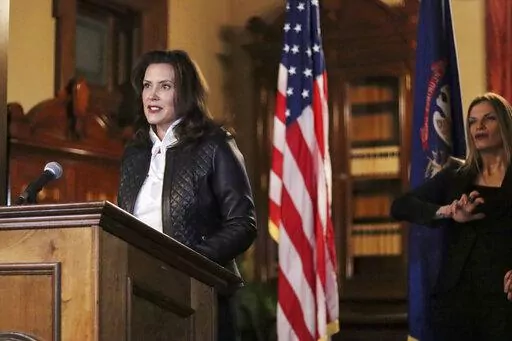 In an Oct. 8, 2020 file photo, provided by the Michigan Office of the Governor, Michigan Gov. Gretchen Whitmer addresses the state during a speech in Lansing, Mich. Opening statements are Wednesday, March 8, 2022, for the trial of four men charged with plotting to kidnap Whitmer. Prosecutors say the men conspired to kidnap the Democratic governor in 2020 because they were angry about COVID-19 restrictions she imposed .(Michigan Office of the Governor via AP File)