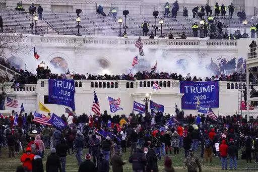 Violent insurrectionists loyal to President Donald Trump, storm the Capitol, Jan. 6, 2021, in Washington. A federal jury is set to resume deliberating in the trial of a former Virginia police officer charged with storming the U.S. Capitol with another off-duty officer. The 12 jurors deliberated for more than four hours on Friday without reaching a verdict in the case against former Rocky Mount police officer Thomas Robertson. (AP Photo/John Minchillo, File)