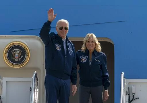 U.S. President Joe Biden waves as first lady Jill Biden watches standing at the top of the steps of Air Force One before boarding at Andrews Air Force Base, Md., Saturday, Sept. 17, 2022. President Biden said during and interview broadcasted on Sunday, Sept. 18, 2022, that U.S. forces would defend Taiwan if China tries to invade the self-ruled island claimed by Beijing as part of its territory, adding to displays of official American support for the island democracy in the face of Chinese intimi
