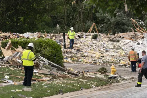 Crew workers remove the debris after a house exploded in Bel Air, Md. neighborhood on Sunday, Aug. 11, 2024. (AP Photo/Jose Luis Magana)