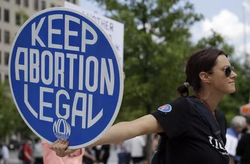 An abortion-rights demonstrator holds a sign during a rally, May 14, 2022, in Chattanooga, Tenn. On Wednesday, April 10, 2024, Republican lawmakers in Tennessee advanced legislation making it illegal for adults to help minors get an abortion without parental consent. (AP Photo/Ben Margot, File)