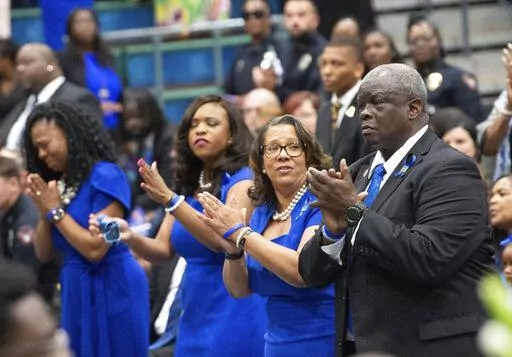 Tears stream down Rev. Kelvin Croom's face as he and his wife, Tracy, join in singing praise songs during the Celebration of Life ceremony for their son, Kennis, Saturday, June 18, 2022, in Tuscaloosa, Ala. Tuscaloosa honored the passing of Meridian, Miss., Police Officer Kennis Croom, a native of Tuscaloosa, with a memorial service at Shelton State Community College. (Gary Cosby Jr./The Tuscaloosa News via AP)